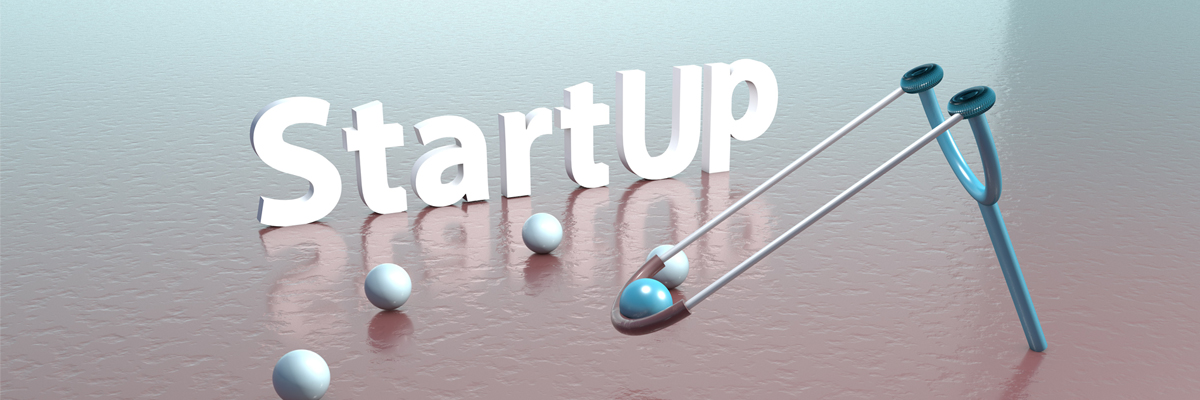 La palabra Startup con unas bolas y un tirachinas