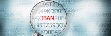 Lupa resaltando la palabra “IBAN” sobre un fondo de caracteres alfanuméricos en tonos grises